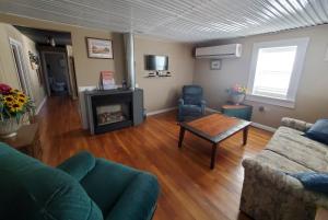 a living room with a couch and a fireplace at VIGILANTE INN Invincible Quarters in Tombstone