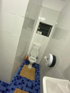 a small bathroom with a toilet and a sink at Bula Re Apartments in Tamavua Heights +7 photos