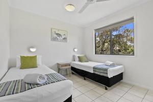 a bedroom with two beds and a window at Ingenia Holidays Hervey Bay in Hervey Bay +27 photos