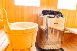 a large bucket and a trash can in a room at BRUCE Luxury House in Izumi-Sano