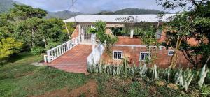 a brick house with a staircase in front of it at La Morada Del Gavilucho in San Carlos