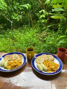 two plates of food on top of a table at La Aldea del Primitivo in Nuquí