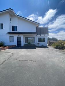 a white house with a driveway in front of it at Lavandine Farm in Watsonville