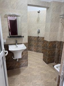 a bathroom with a sink and a shower at Central Private Rooms Kathmandu in Kathmandu