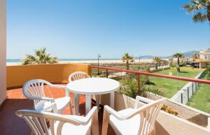 a balcony with a table and chairs and the beach at Apartamento Tortuga I in Tarifa +11 photos