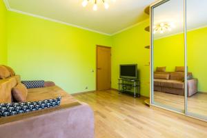 a living room with a couch and a television at Star Apartment On Kyievskaya in Moscow