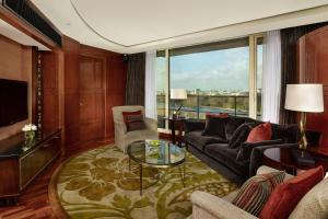 a living room with a couch and a table at The Park Tower Knightsbridge, a Luxury Collection Hotel, London in London