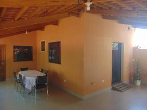 a dining room with a table and chairs at Plamary Recanto do Sossego, Casa 01 in Sinop