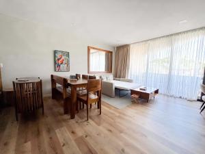 a living room with a table and a dining room at Spacious Apartment with Balcony in El Zonte