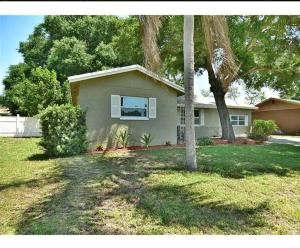 a house with a palm tree in a yard at Beach House in Largo