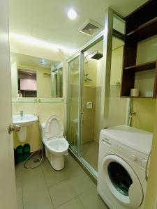 a bathroom with a toilet and a sink and a shower at 1205T2 Avida Riala IT Park 1BR Unit 400Mbps Internet in Cebu City