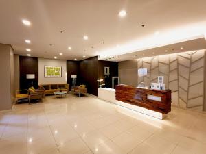 a lobby of a hotel with couches and a waiting room at 1205T2 Avida Riala IT Park 1BR Unit 400Mbps Internet in Cebu City +46 photos