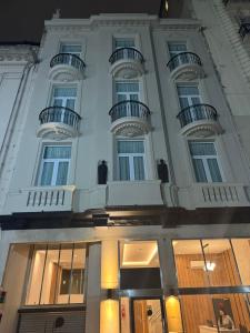 a white building with balconies on top of it at Up Central Córdoba in Buenos Aires