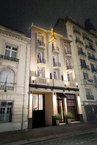 a large white building at night with lights on it at Up Central Córdoba in Buenos Aires