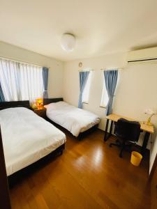 Ένα ή περισσότερα κρεβάτια σε δωμάτιο στο Warm family stay ーEasy Access Kyoto & Osaka ー
