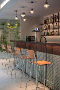 a row of chairs and a table and a bar at Guangzhou Desti Youth Hostel - Rainbow Bridge Metro Station in Guangzhou