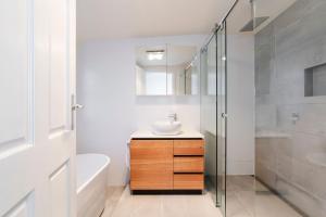 a bathroom with a sink and a shower at Rivulet Retreat - Cosy South Hobart Home & Parking in West Hobart +29 photos