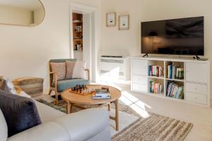 a living room with a couch and a table at Rivulet Retreat - Cosy South Hobart Home & Parking in West Hobart