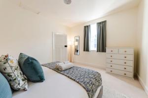 a bedroom with a bed and a dresser at Rivulet Retreat - Cosy South Hobart Home & Parking in West Hobart