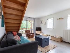 a living room with a couch and a stair case at Duplex 11 personnes, 50m télécabine, Wi-Fi, parking - FR-1-695-81 in Loudenvielle