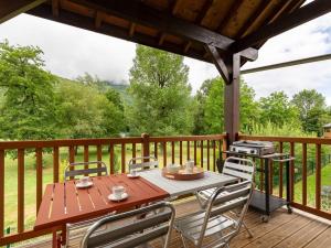 a table and chairs on a deck with a grill at Duplex 11 personnes, 50m télécabine, Wi-Fi, parking - FR-1-695-81 in Loudenvielle