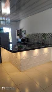 a kitchen with a black and white counter top at Cabaña aldea primaveral in Doradal +18 photos