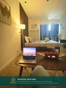 a room with a table with a laptop on it at Novotel Tower at Mandaluyong Rockwell View in Manila