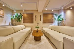 a waiting room with couches and a table at Hta Tailored Service Home&fitness Near Seoul Stn in Seoul