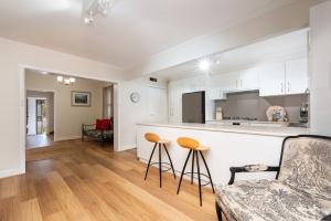 メルボルンにあるBank House Port Melbourneのキッチン、リビングルーム(カウンター、スツール付)