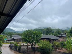 a view of a village with mountains in the background at Stay with sumo homestay in Chiang Mai