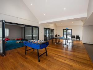 a living room with two ping pong tables in it at Cape View 26 Your Perfect Coastal Retreat in Broadwater
