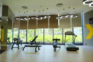 a gym with treadmills and exercise equipment in a room at Modern Beach Apartment - Arena Resort Cam Ranh in Cam Ranh International Airport