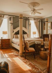 a bedroom with a bed and a ceiling fan at The Magnolia Mansion 6 Minutes to Broadway on 4 Acres in Nashville +72 photos