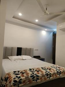 a bedroom with a bed with a flower blanket on it at Arnnapurna Hotel & Resort in Jājpur