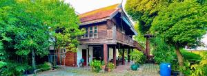 an old house with trees in front of it at Was Na Yajai  +23 photos