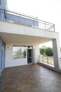 a balcony of a house with a stair case at Hotel Marant in Sozopol