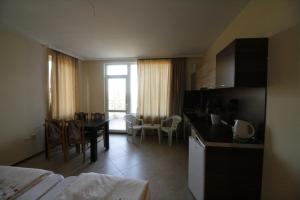 a room with a kitchen and a dining room at Hotel Marant in Sozopol