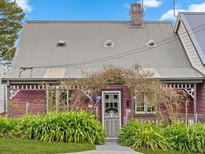 a red house with a gray roof at Broughton Cottage in Katoomba