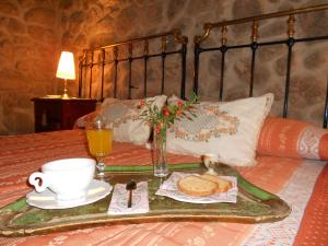 a tray with a breakfast on top of a bed at El Balcon de Los Sueños in Trevejo