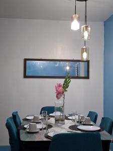 a dining room table with a vase of flowers on it at Casa Lumain 