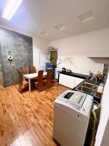 a kitchen and dining room with a table and chairs at Hoa dalathouse in Da Thanh