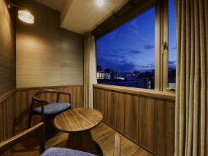 a balcony with a table and chairs and a window at Village Kyoto close by Shijo Omiya station in Kyoto +45 photos