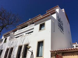 a white building with a sign on the side of it at The Salty Lodge in Lagos