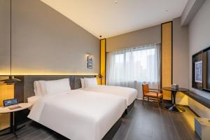 UrCove by HYATT Shanghai Jinqiao Centre 객실 침대