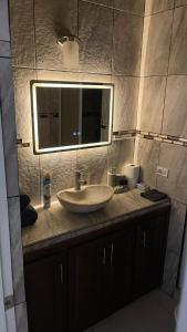 a bathroom with a sink and a mirror at Casa Marlin in Mulegé +11 photos