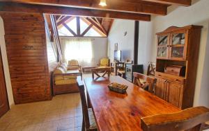 a dining room with a table and a living room at Sonnen Haus in Villa General Belgrano