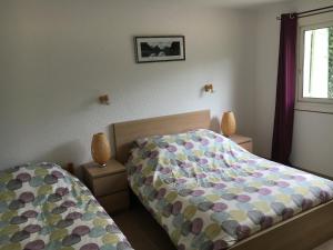 מיטה או מיטות בחדר ב-Les Mimosas Apartments