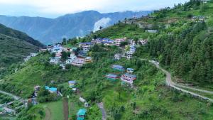 an aerial view of a village on a mountain at The Mud house, Mussoorie in Mussoorie