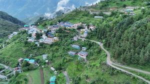 an aerial view of a village on a mountain at The Mud house, Mussoorie in Mussoorie