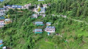 an aerial view of a village on a hill with houses at The Mud house, Mussoorie in Mussoorie +4 photos